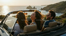 Friends Enjoying a Sunset Drive in Convertible by the Ocean