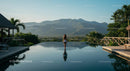 Woman Relaxing by Infinity Pool with Mountain View