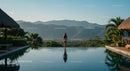 Woman Standing by Infinity Pool Overlooking Tropical Mountains