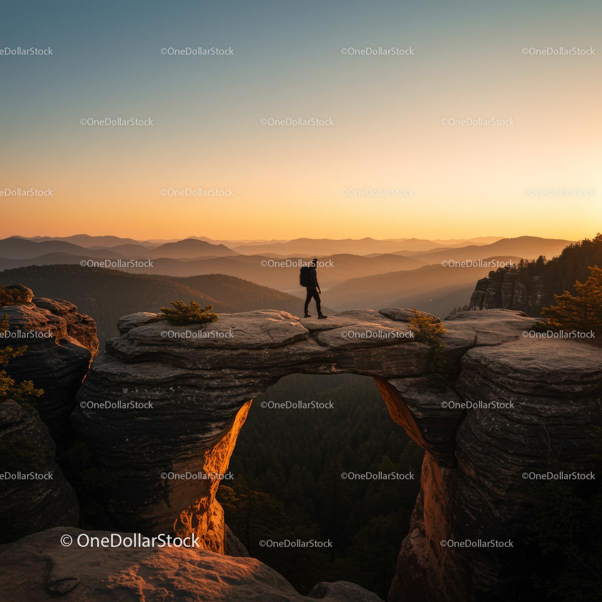 Silhouette of Hiker on Rock Arch during Golden Sunset