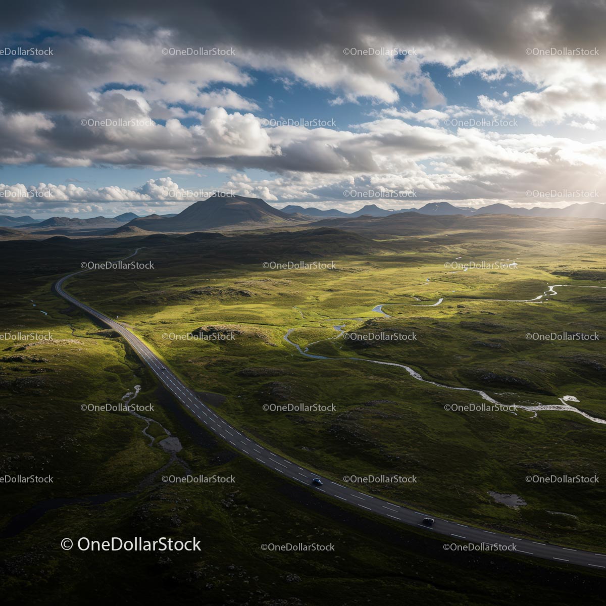 Scenic Road Through Vast Green Landscape Under Dramatic Sky