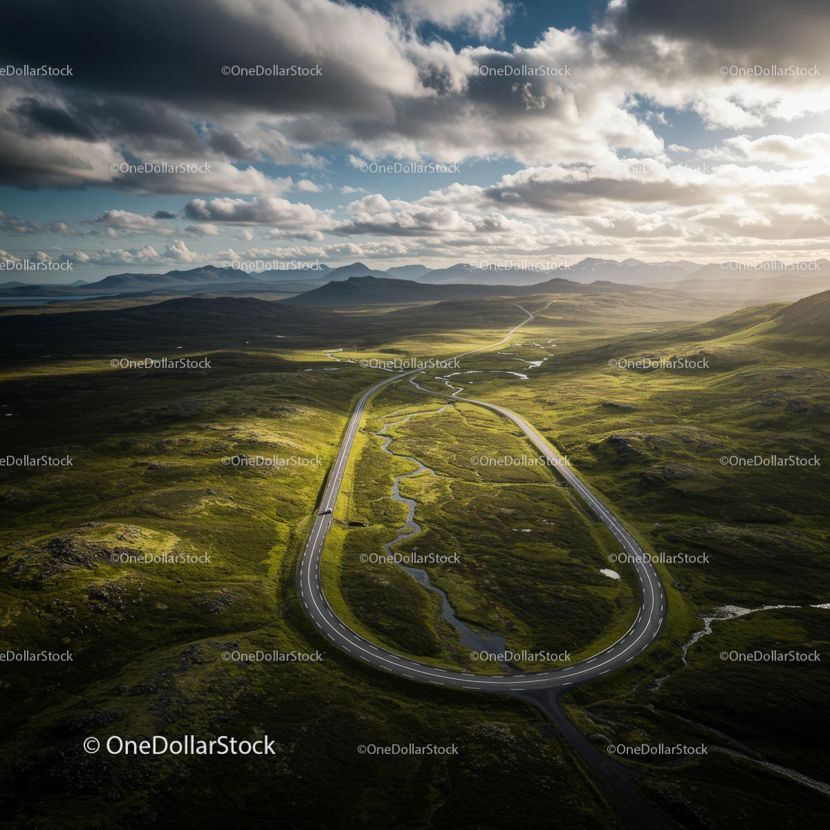 Winding Road Through Scenic Green Valley and Mountains