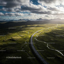 Winding Road Through Lush Green Landscapes and Mountains