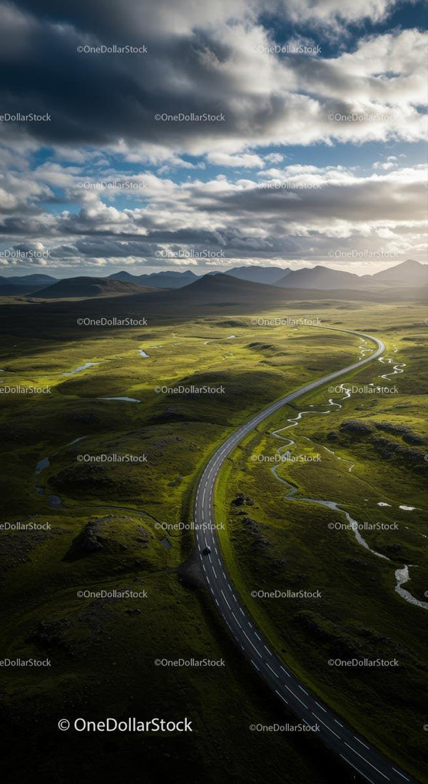 Scenic Road Through Lush Green Highlands Under Dramatic Sky