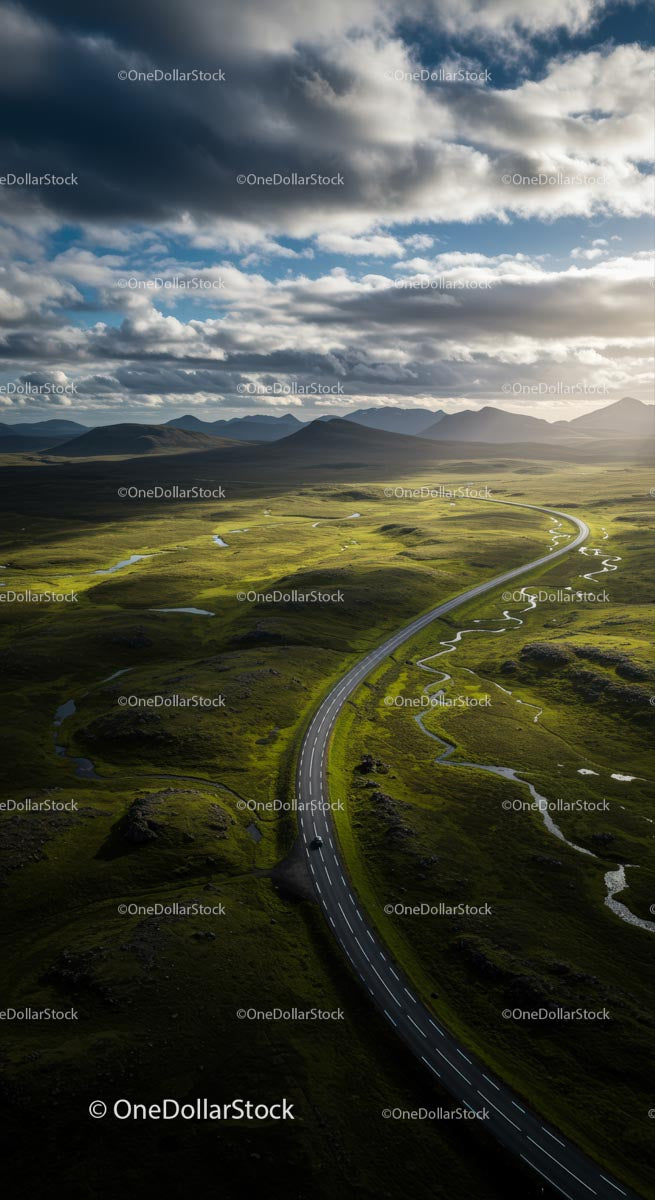 Scenic Road Through Lush Green Highlands Under Dramatic Sky