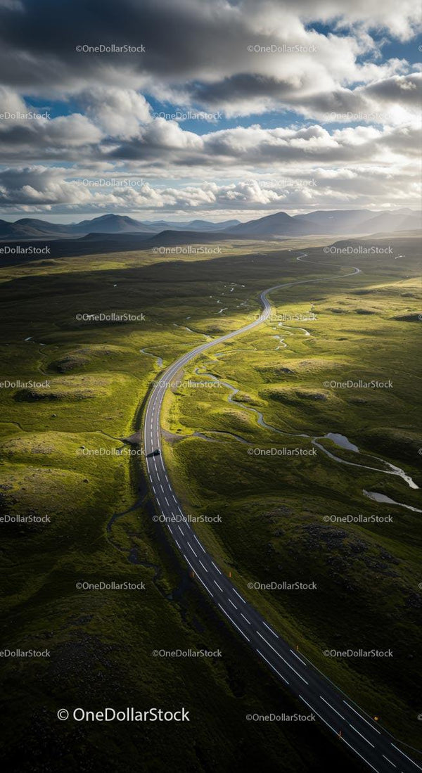 Winding Road Through Lush Green Landscape Under Moody Skies