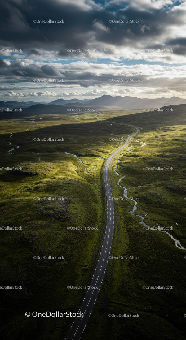 Winding Road through Vast Green Plains under Dramatic Clouds