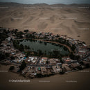 Aerial View of Desert Oasis Surrounded by Sand Dunes
