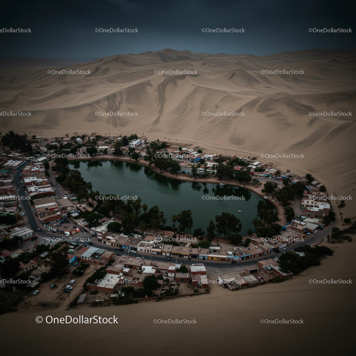 Aerial View of Huacachina Oasis Surrounded by Sand Dunes