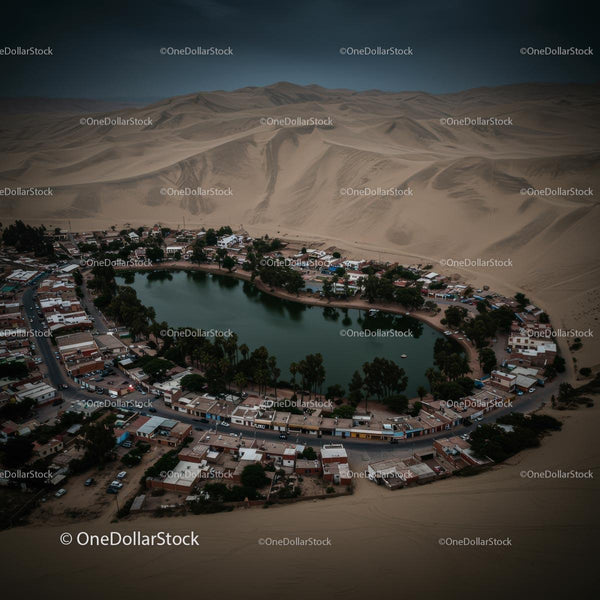 Aerial View of Huacachina Oasis Surrounded by Sand Dunes