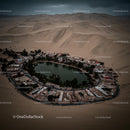 Aerial View of an Oasis Surrounded by Desert Sand Dunes