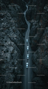 Cars on Winding Road Through Majestic Canyon Landscape