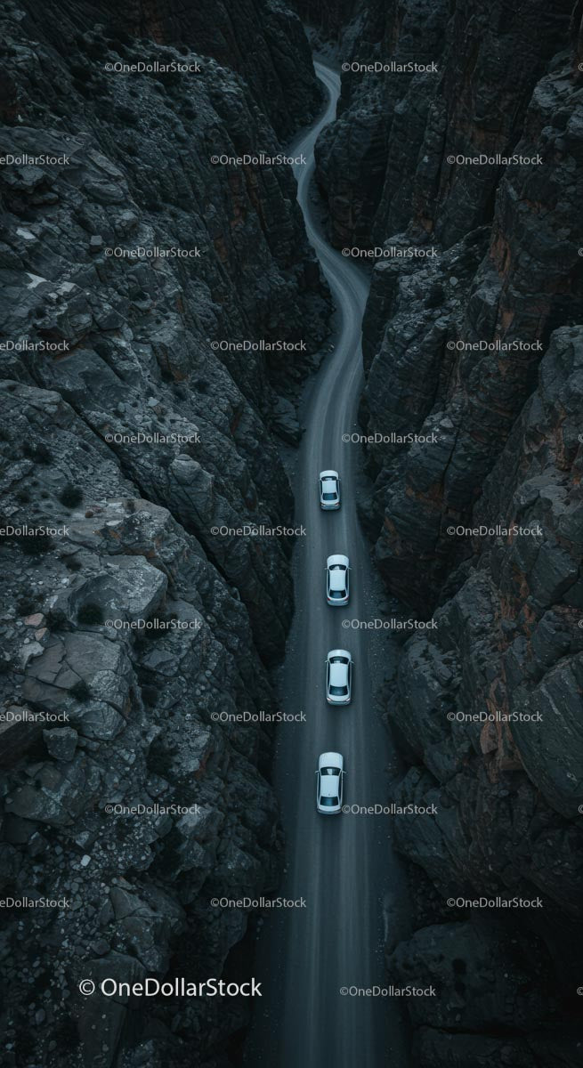 Cars on Winding Road Through Majestic Canyon Landscape