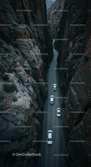Cars Navigating a Narrow Canyon Road from Above