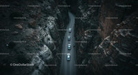 Aerial View of Cars Navigating a Narrow Canyon Road