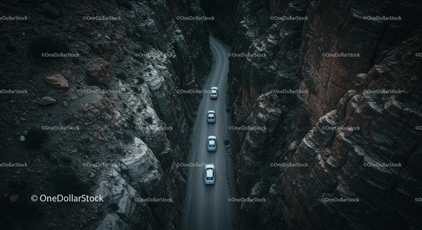 Aerial View of Cars Navigating a Narrow Canyon Road
