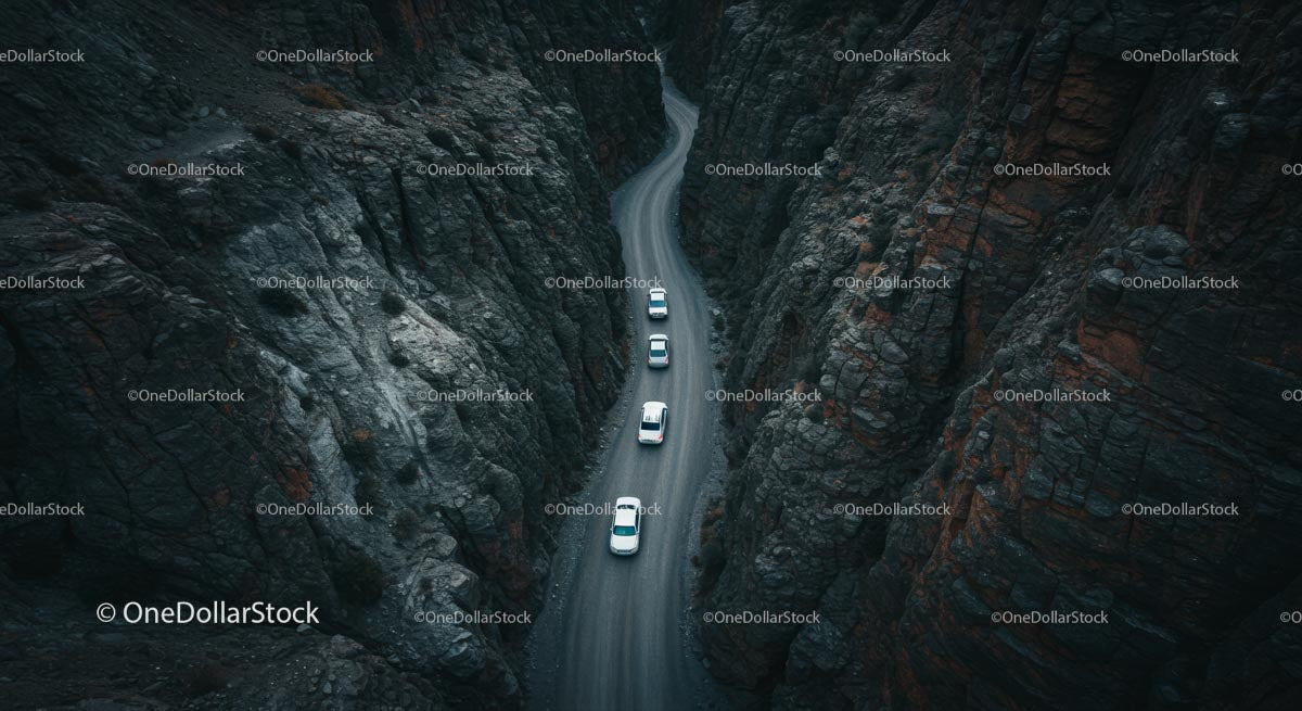 Cars Navigating a Curvy Road Through Majestic Canyon