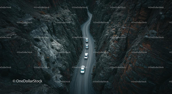 Cars Navigating a Curvy Road Through Majestic Canyon