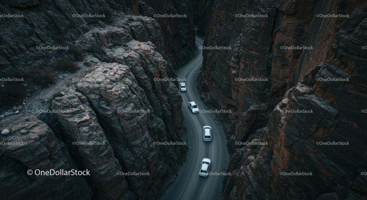 Cars Navigating a Serpentine Road Through Steep Canyon