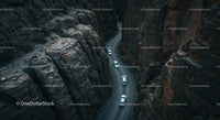 Cars Navigating a Serpentine Road Through Steep Canyon