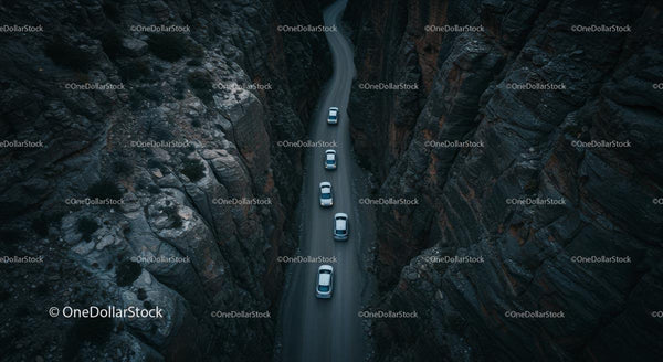 Aerial View of Cars Driving Through Narrow Mountain Canyon