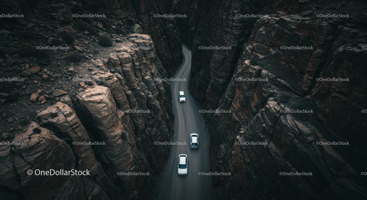 Aerial View of Cars Navigating a Winding Canyon Road