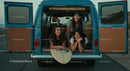 Friends Enjoying a Road Trip in a Blue Van