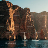 Sailing Boats Near Dramatic Rocky Cliffs at Sunset