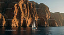 Sailing Boat Beneath Majestic Sunset Cliffs