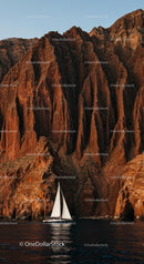 Sailing Yacht Beneath Majestic Red Rock Cliffs