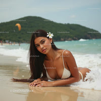 Woman Sunbathing on Tropical Beach with Flower in Hair