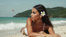 Woman Relaxing on Tropical Beach with Plumeria Flower