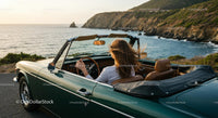 Two Women Driving Vintage Convertible by Ocean