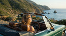 Two Women Driving Vintage Convertible by Ocean