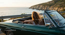 Two Women Driving Vintage Convertible by Ocean