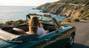 Woman Enjoying Convertible Drive Along Scenic Coastal Route