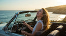 Joyful Woman Driving by the Sea at Sunset