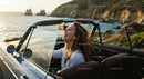 Friends on a Coastal Road Trip in Convertible Car