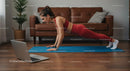 Woman in Plank Position on Blue Yoga Mat During Home Workout