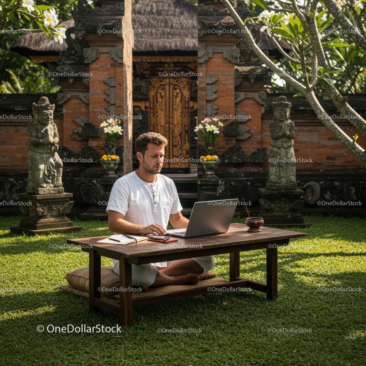 Man Working on Laptop in Serene Balinese Garden