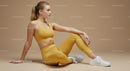 Woman in Yellow Athletic Gear Sitting on Beige Background