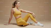 Woman in Yellow Athletic Gear Sitting on Beige Background