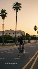 Cyclist Enjoying Evening Ride Along Palm-Lined Streets