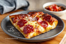 Pepperoni Pizza Slice on a Gray Plate