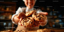 Smiling Baker Offering Freshly Baked Chocolate Chip Cookies