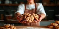 Hands Presenting Freshly Baked Chocolate Chip Cookies