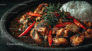 Spicy Chicken with Red Chili and Rosemary Garnish