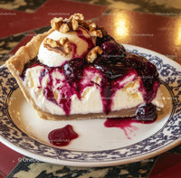 Berry-Topped Cheesecake with Ice Cream and Walnut Garnish