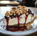 Slice of Creamy Cheesecake with Berry Topping and Walnuts