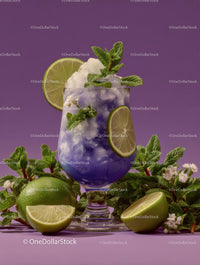 Refreshing Purple Cocktail Garnished with Mint and Lime